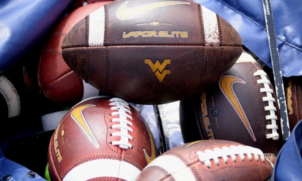WVU Football logo on footballs stock