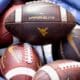 WVU Football logo on footballs stock