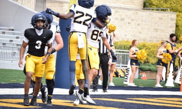 WVU Football QB Michael Hawkins near WR Robert Oliver and RB Chris Talley celebrating during a scrimmage