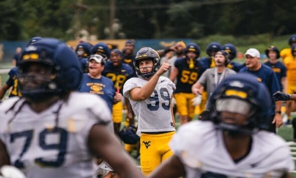 WVU Football team celebrate after Ethan Head makes kick at practice