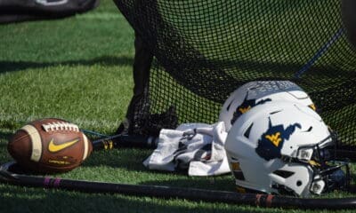 WVU Football white helmets and football stock