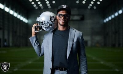 Geno Smith holding Raiders jersey
