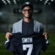 Geno Smith holding Raiders jersey