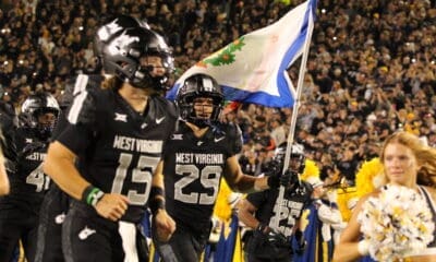 WVU Football WR Preston Fox with flag before Coal Rush game