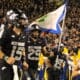 WVU Football WR Preston Fox with flag before Coal Rush game