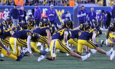 WVU Football team stretching stock photo with Rodney Gallagher