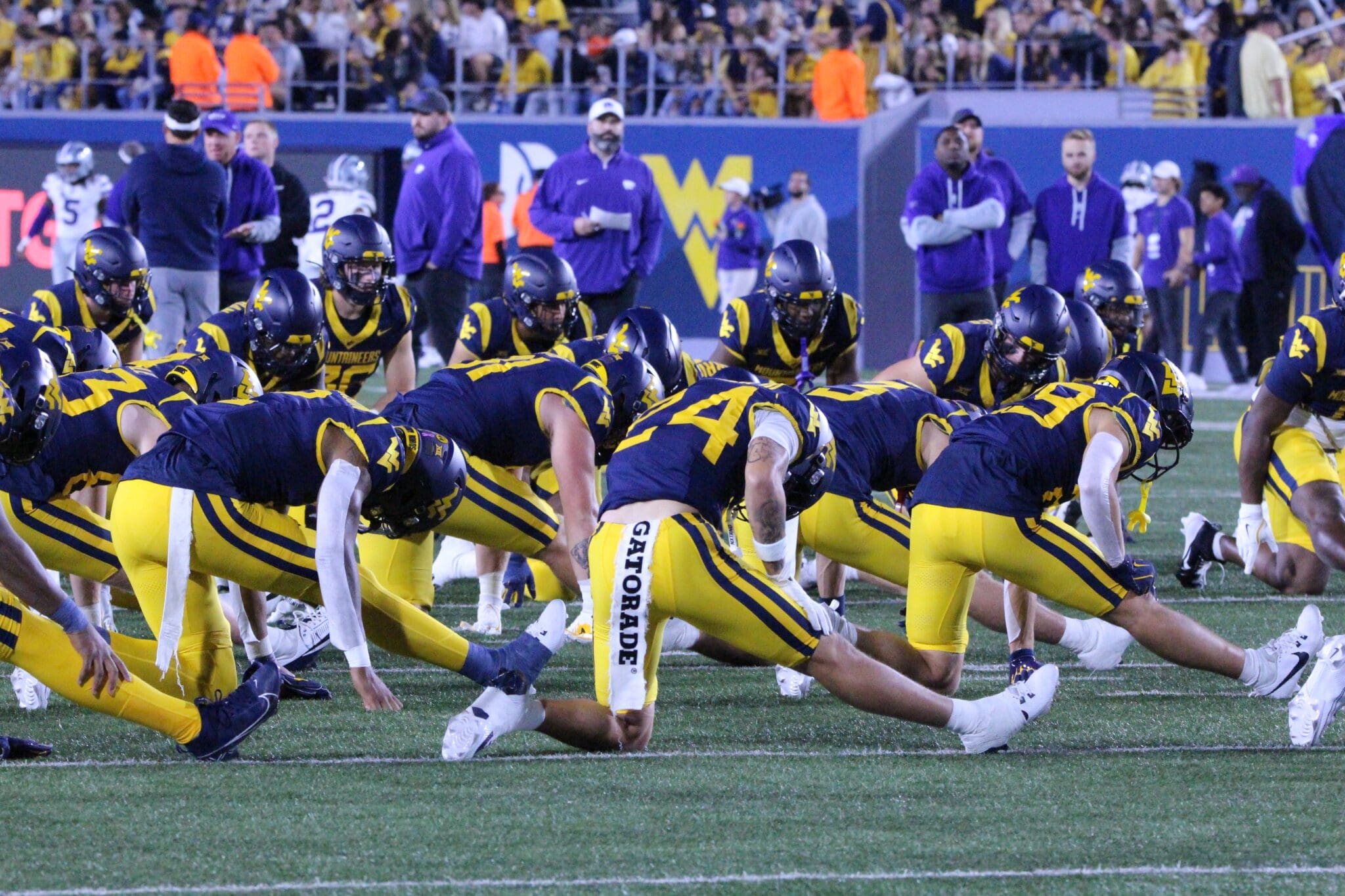 WVU Football team stretching stock photo with Rodney Gallagher