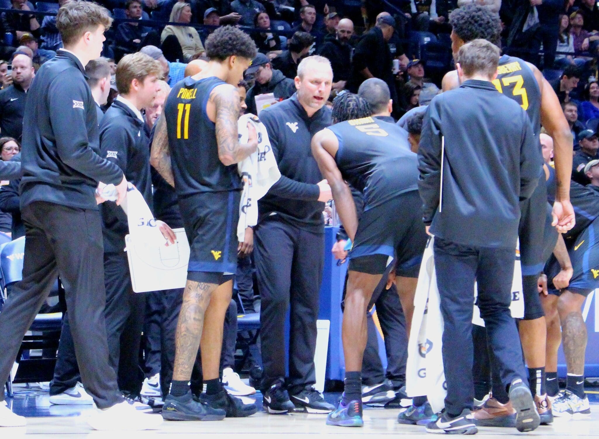 WVU Basketball HC Darian DeVries in WVU basketball huddle
