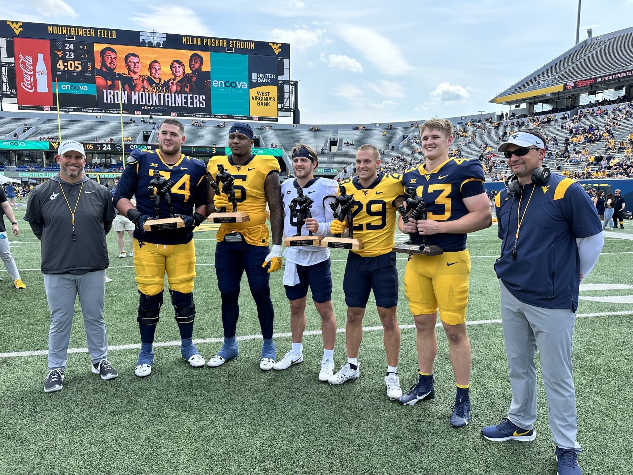 WVU Football HC Neal Brown with spring award winner