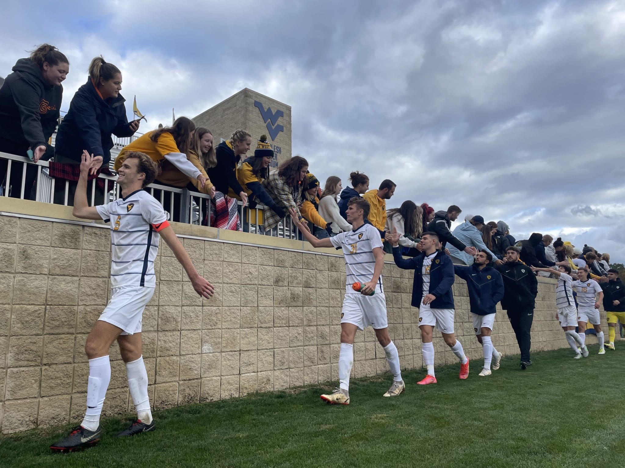WVU men's soccer celebrates with fans