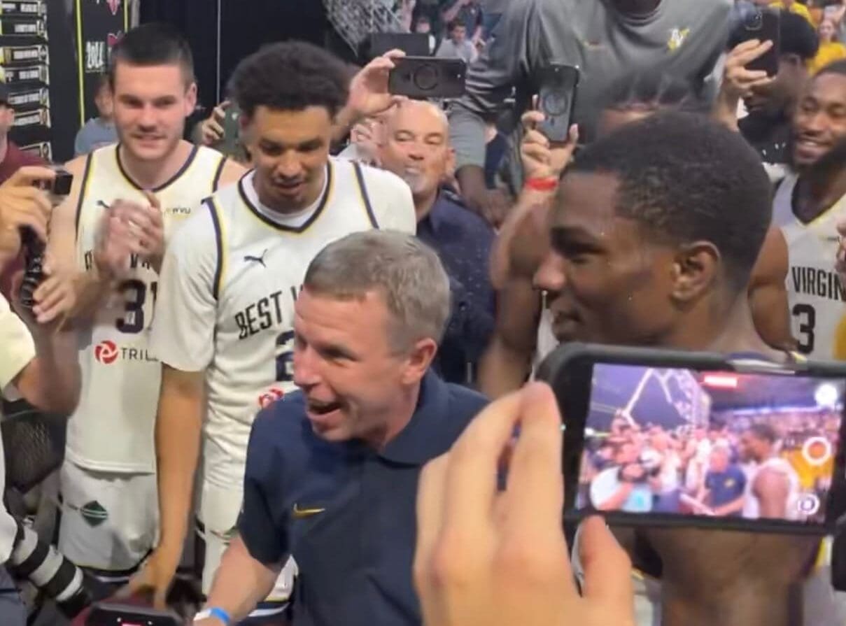 WVU Basketball HC Ross Hodge celebrating with Best Virginia team