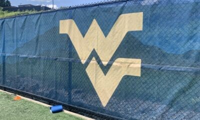 WVU Football stock logo on practice field wall