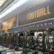 WVU Football conference titles on wall of weight room stock