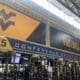 WVU Football conference titles on wall of weight room