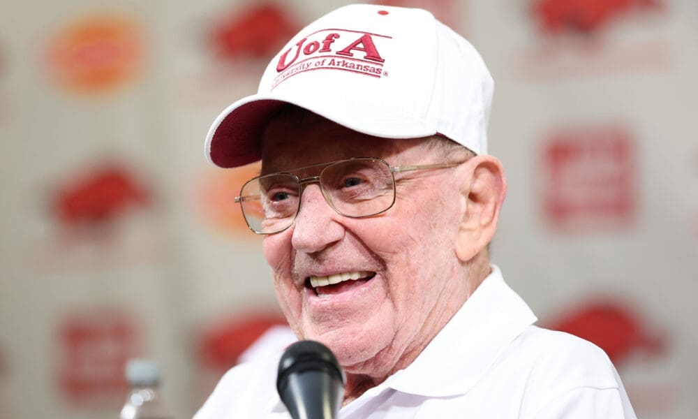 Lou Holtz with Arkansas hat on