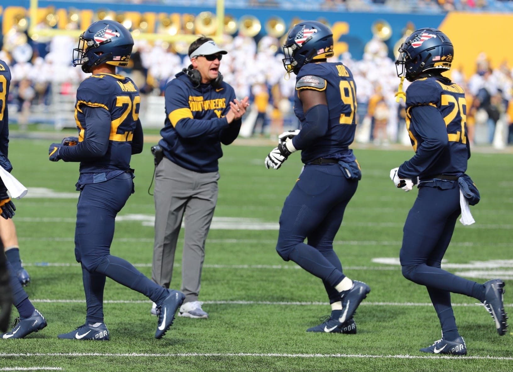 Neal Brown with WVU Football team