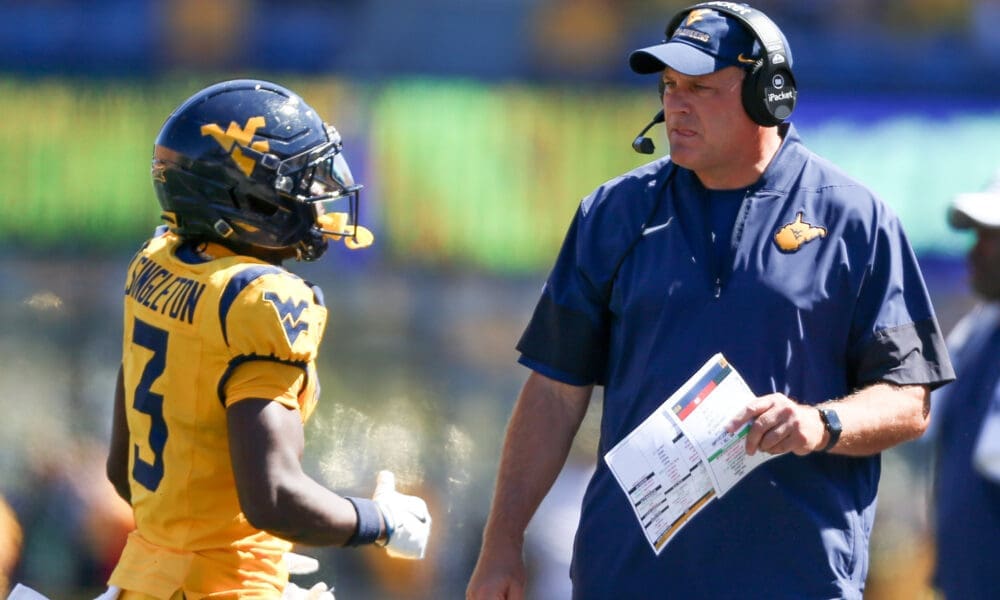 WVU Football HC Rich Rodriguez talks to Oran Singleton in season opener against RMU