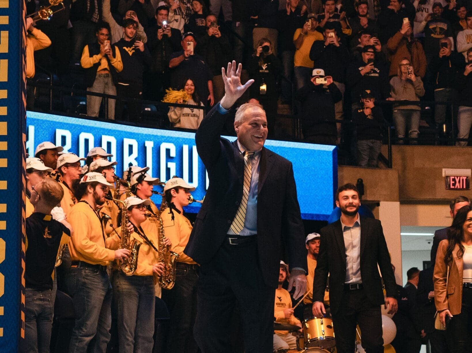 WVU Football HC Rich Rodriguez waving to WVU fans with his son Rhett and family