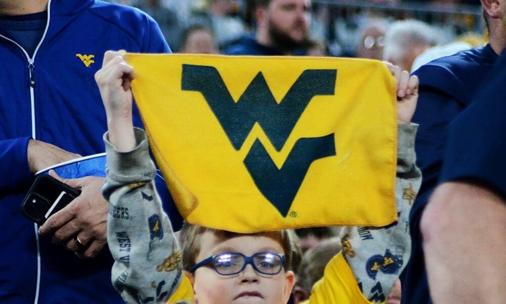 A young WVU fan holds up a towel at the Duke's Mayo Bowl on Dec. 27, 2023 at Bank of America Stadium in Charlotte, N.C. (Mitchell Northam / WV Sports Now)