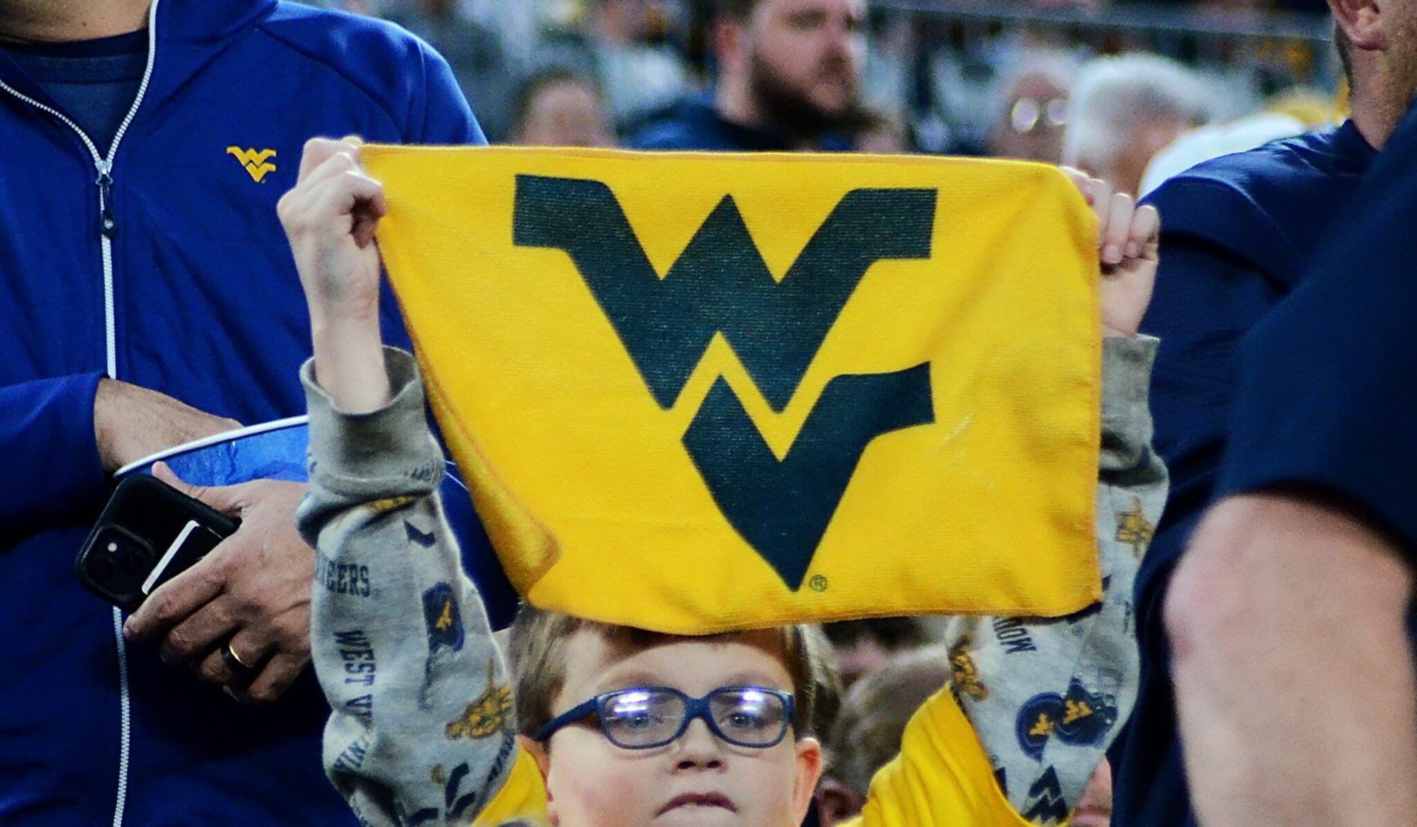 A young WVU fan holds up a towel at the Duke's Mayo Bowl on Dec. 27, 2023 at Bank of America Stadium in Charlotte, N.C. (Mitchell Northam / WV Sports Now)