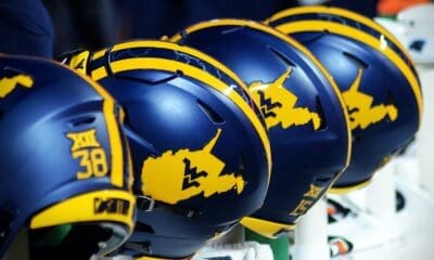 WVU Football helmets rests on the sideline stock