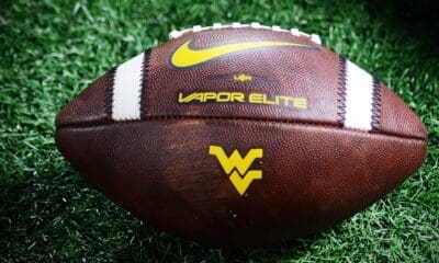 A WVU football rests on the sideline at the Duke's Mayo Bowl