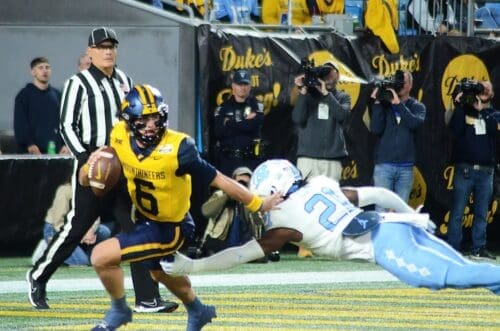 WVU Football quarterback Garrett Greene scrambles against UNC in the Duke's Mayo Bowl at Bank of America Stadium in Charlotte, N.C. on Dec. 27, 2023. (Mitchell Northam / WV Sports Now)