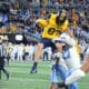 WVU Football tight end Kole Taylor attempts to hurdle a UNC defender in the Duke's Mayo Bowl at Bank of America Stadium in Charlotte, N.C. on Dec. 27, 2023. (Mitchell Northam / WV Sports Now)