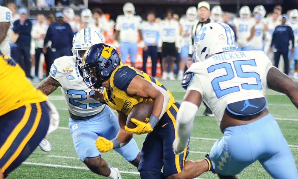 WVU running back Jahiem White rushes against UNC in the Duke's Mayo Bowl at Bank of America Stadium in Charlotte, N.C. on Dec. 27, 2023. (Mitchell Northam / WV Sports Now)