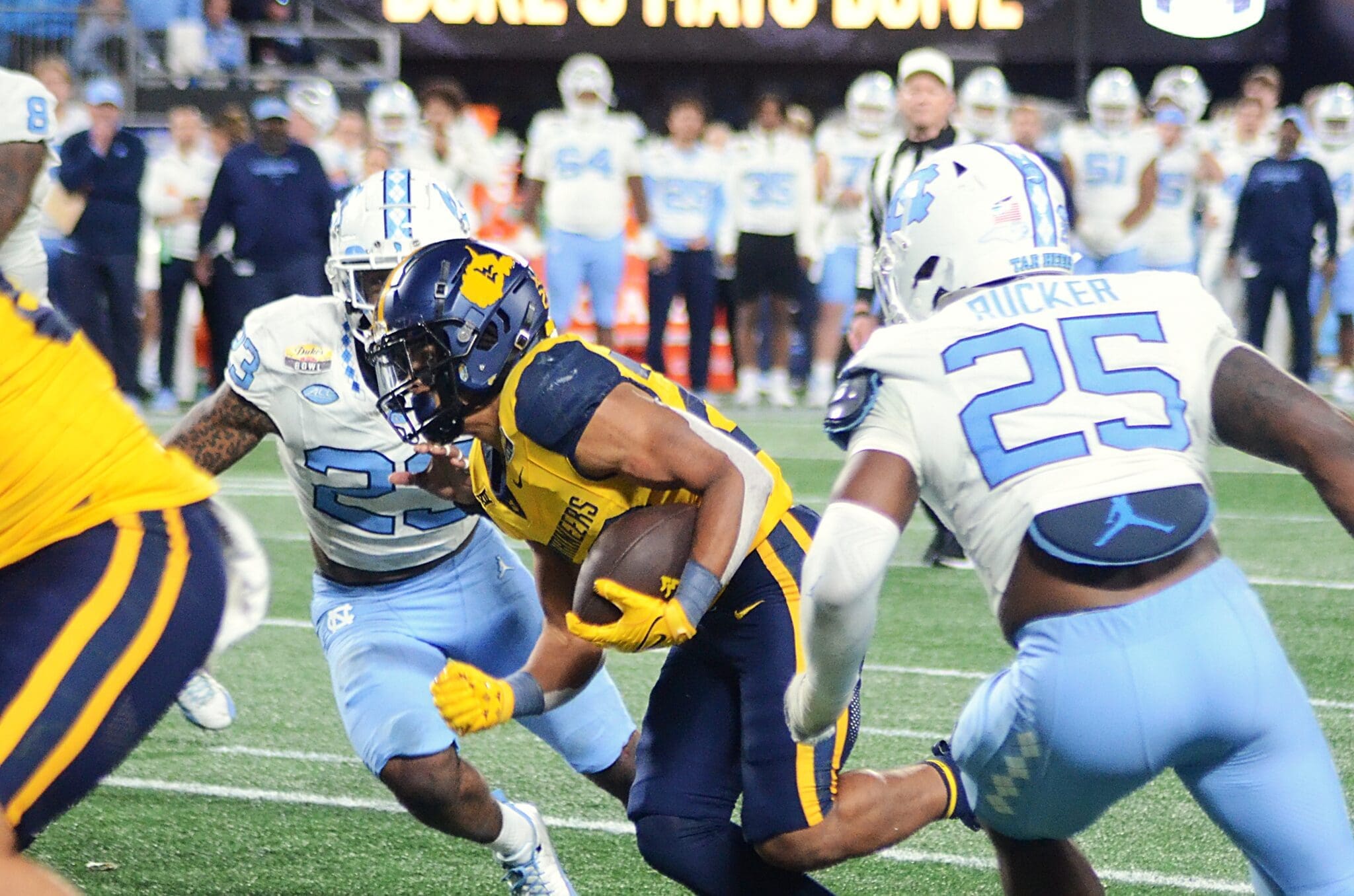 WVU running back Jahiem White rushes against UNC in the Duke's Mayo Bowl at Bank of America Stadium in Charlotte, N.C. on Dec. 27, 2023. (Mitchell Northam / WV Sports Now)