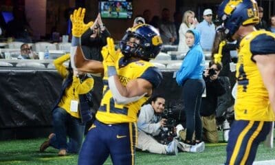 WVU running back Jahiem White celebrates his touchdown against UNC in the Duke's Mayo Bowl at Bank of America Stadium in Charlotte, N.C. on Dec. 27, 2023. (Mitchell Northam / WV Sports Now)