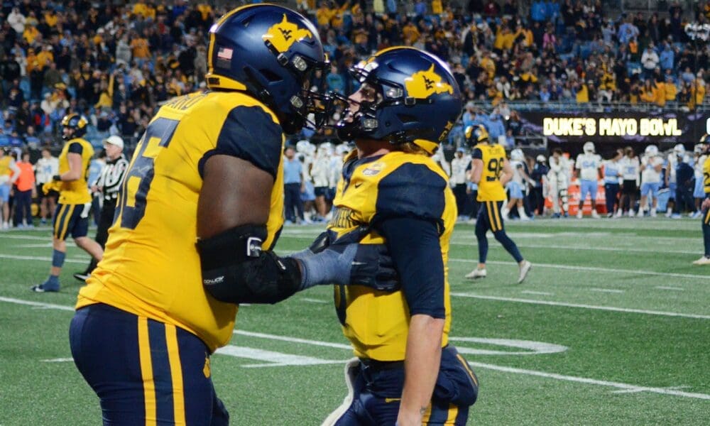 WVU Football Ja'Quay Hubbard and Garrett Greene celebrate a touchdown against UNC in the Duke's Mayo Bowl at Bank of America Stadium in Charlotte, N.C. on Dec. 27, 2023. (Mitchell Northam / WV Sports Now)