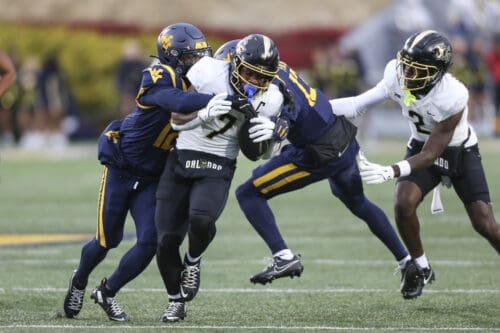 WVU Football safety Anthony Wilson tackles RJ Harvey