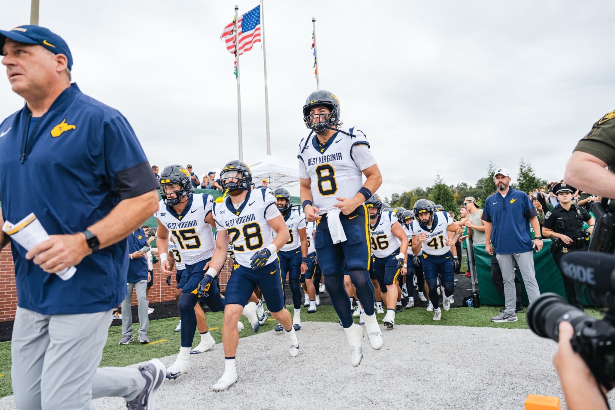 WVU Football HC Rich Rodriguez and Nicco Marchiol lead team on field at Ohio