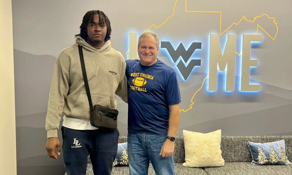 WVU Football OL Jonas Muya and Rich Rodriguez