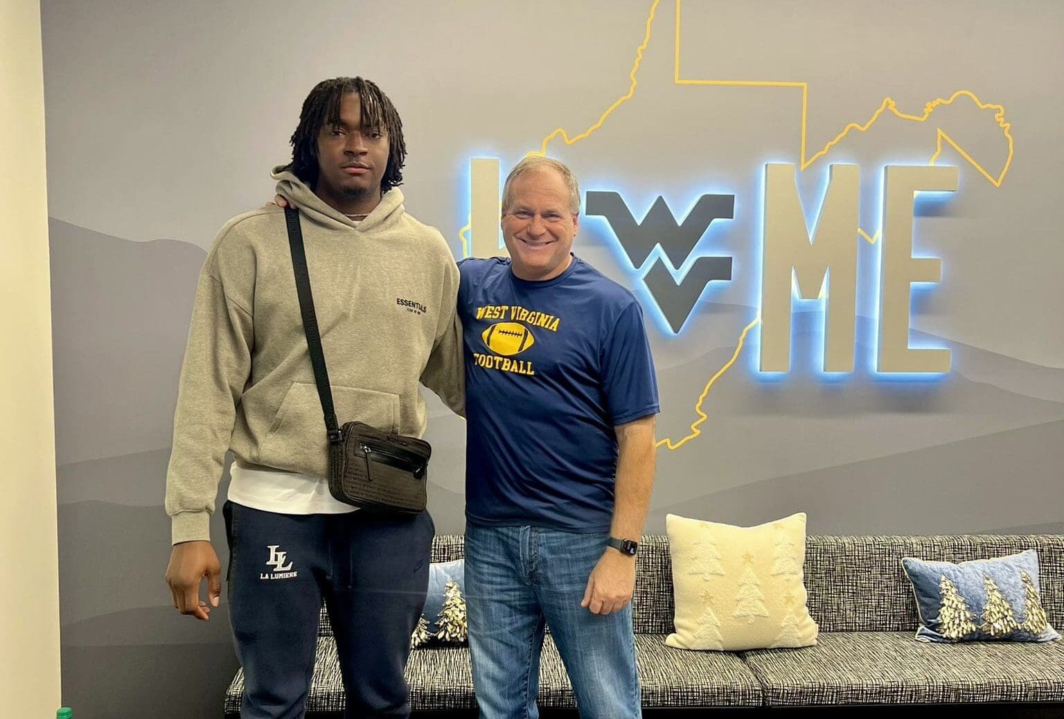 WVU Football OL Jonas Muya and Rich Rodriguez