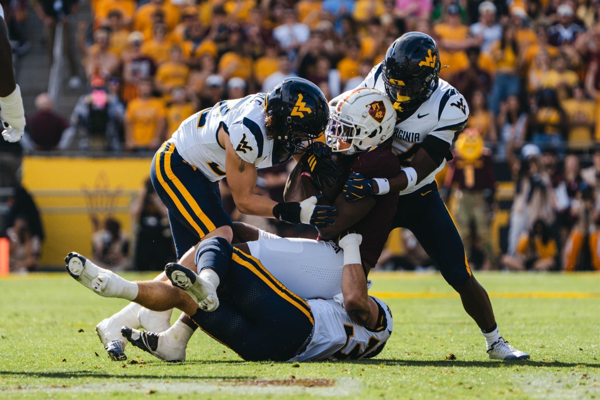 WVU Football defense making tackle at ASU