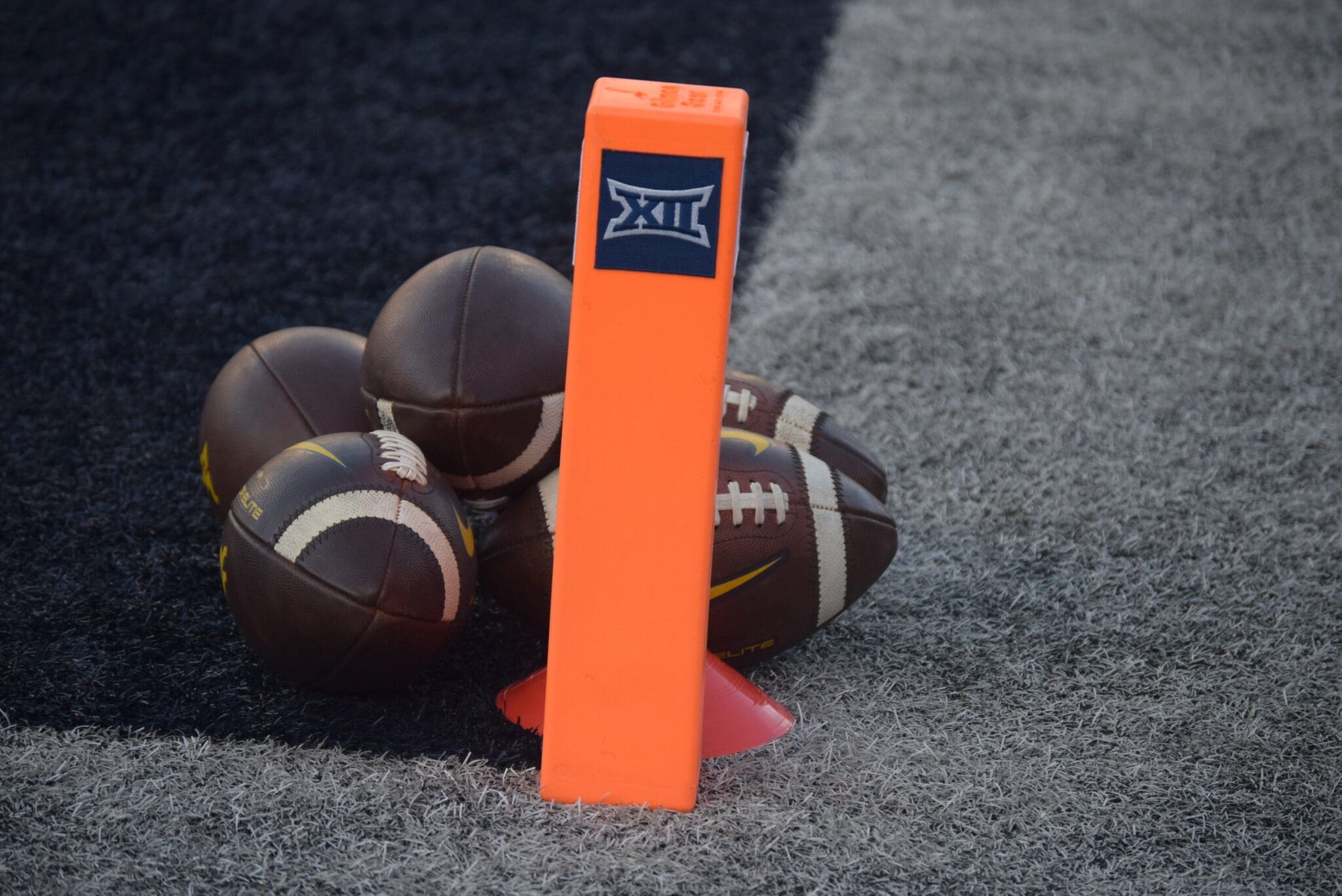 WVU Football Big 12 logo with footballs stock