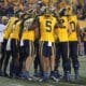 WVU Football Offense huddling with Devin Carter