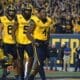 WVU Football Nicco Marchiol, CJ Donaldson, Devin Carter CJ helmet off