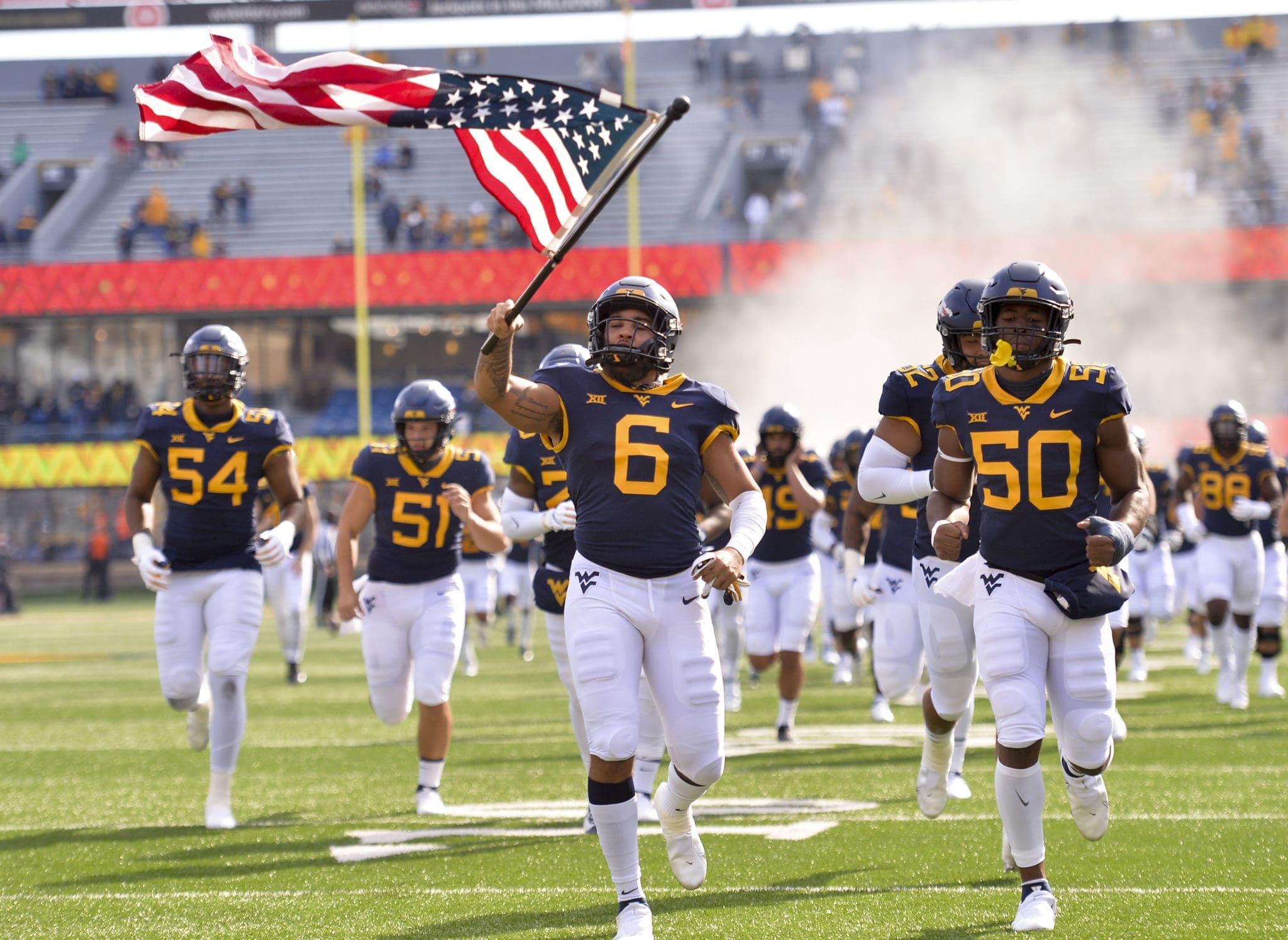 WVU Football team with flag